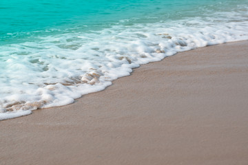 Idyllic tropical beach with Soft waves of turquoise ocean water