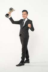 Obraz premium Businessman holding trophy with succesful concept.