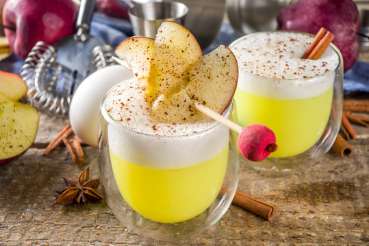 Apple cider sour card cocktail. Autumn Egg Flip alcohol beverage in shot glasses