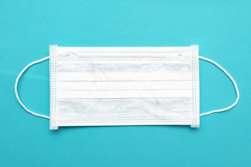 White antibacterial medical mask on a blue background