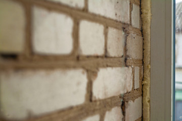 profile of a plastic window near a brick wall. example of proper window installation
