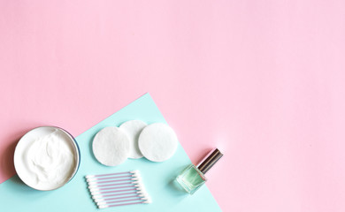  Skin cleansing and daily care products. Hygiene items with top view and copy space on a pastel pink background