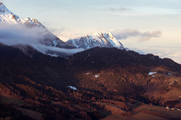 sunset in the mountains with tiny hut