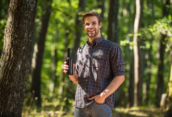 relax on summer picnic weekend. camping season begin. he loves hiking. tourism adventure concept. drinking beer in camping. do not leave garbage in forest. ecology pollution. man drink beer in forest