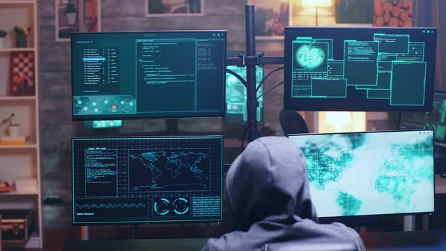 Back view of cyber terrorist using supercomputer