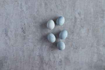 blue eggs on a cement background for Easter top view