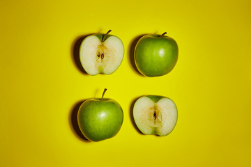 Green apple on yellow background. Flat lay, top view, copy space . Food dietary concept.