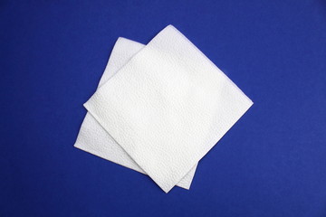 White square napkins on a blue background