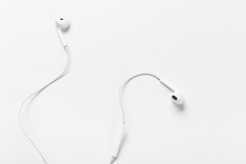 White modern headphones with a headset on a light gray background