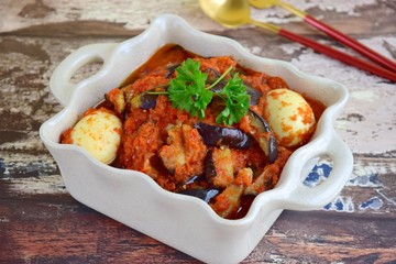 Terong Balado Telur, eggplant and egg with spicy chili sauce garnish with parsley. Indonesian cuisine