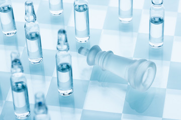 Vaccine for the virus. Medical ampoules on a chessboard, defeat the king. Concept cure for...