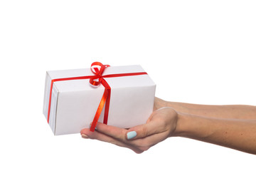hand holds beautiful gift box with bow isolated on white background