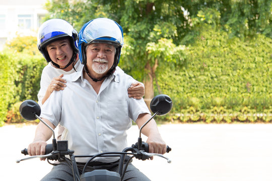 Senior asian couple riding motorcycle, Happy active old age and lifestyle concept