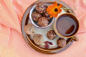 Fig cranberry quinoa energy balls. Vegan protein balls. Served with tea. Flat lay