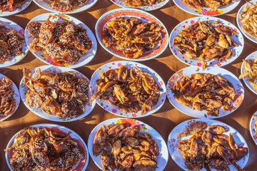 Many kinds of deep fried fish on dish for sale at street food in Thailand.