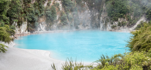 clear blue waters of "Inferno Crater" at Waimangu valley park, Rotorua, New Zealand