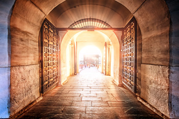 moscow kremlin gate entrance famous russian architecture landmark interior view against setting sun background. Vintage gate with bridge to ancient fortress. Tourist attraction