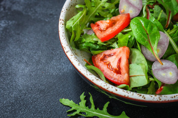 healthy salad tomato, mix leaves, onions and other ingredients, vegan, keto or paleo menu concept. top food background. copy space