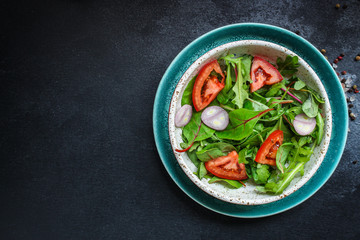 healthy salad tomato, mix leaves, onions and other ingredients, vegan, keto or paleo menu concept. top food background. copy space