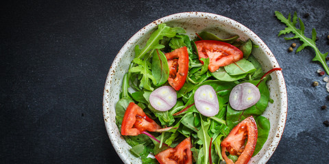 healthy salad tomato, mix leaves, onions and other ingredients, vegan, keto or paleo menu concept. top food background. copy space