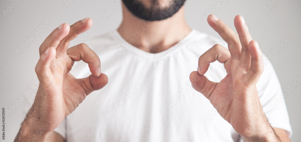 Wall mural caucasian man showing ok gesture.