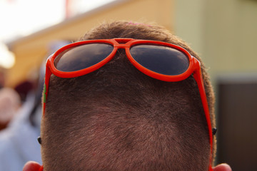 Rear view of a Head of young man with short hair with fun sunglasses. idea of closing eyes to...