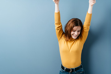 Happy young woman stretching her arms smiling