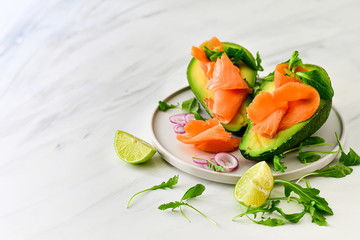 keto diet food : salmon and avocado  with arugula and lime. healthy lunch. ketogenic diet  food