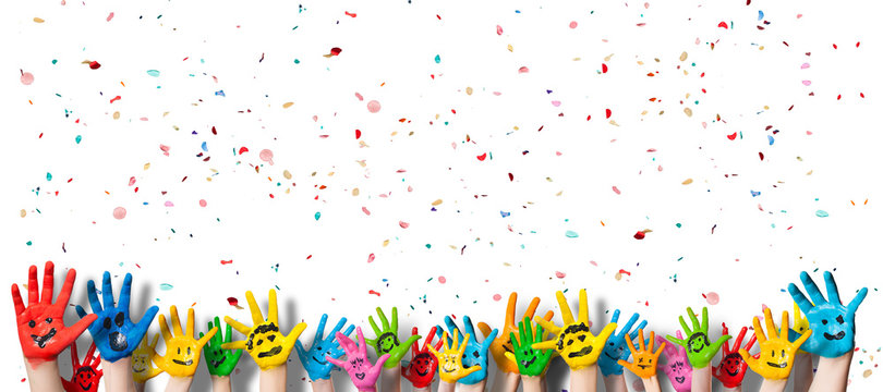 many painted kids hands with smileys in front of white background with confetti