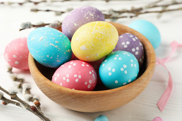 Composition with Easter eggs on white wooden background, close up