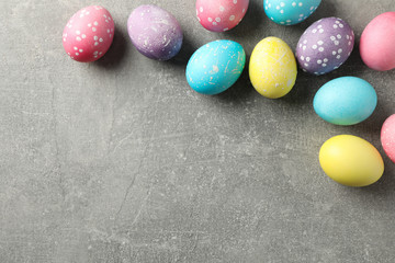 Multicolor Easter eggs on grey background, space for text