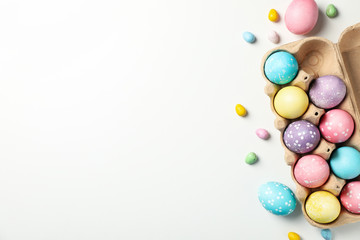 Multicolor Easter eggs on white background, top view