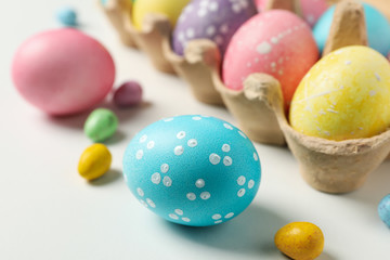 Obraz na płótnie Canvas Multicolor Easter eggs on white background, close up