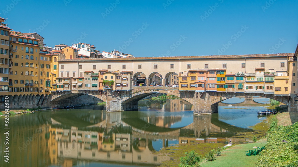 Wall mural view on the ponte vecchio on a sunny day timelapse, a medieval stone segmental arch bridge over the 