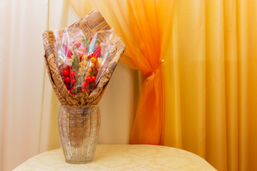 The bouquet consists of food. Sausages, cheese and vegetables are made in the form of a bouquet.