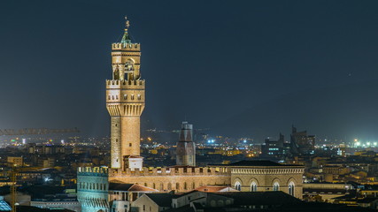 Fototapeta premium Famous Arnolfo tower of Palazzo Vecchio timelapse on the Piazza della Signoria at twilight in Florence, Tuscany, Italy