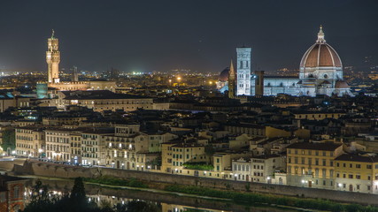 Fototapeta na wymiar Famous Arnolfo tower of Palazzo Vecchio timelapse and Basilica di Santa Maria del Fiore at night in Florence, Tuscany, Italy