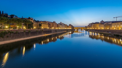 Fototapeta na wymiar River Arno and famous bridge Ponte Vecchio day to night timelapse after sunset from Ponte alle Grazie in Florence, Tuscany, Italy