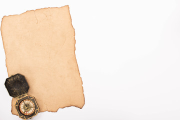 top view of vintage compass on aged paper isolated on white