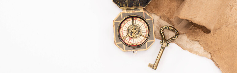 Fototapeta na wymiar top view of vintage key, compass and aged paper isolated on white, panoramic shot
