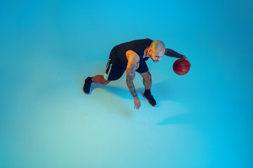 Top view. Young basketball player of team wearing sportwear training, practicing in action, motion...