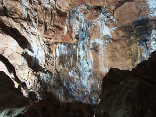 Under the ground. Beautiful view of stalactites and stalagmites in an underground cave-Skelskaya cave, South-West of Crimea. Speleology, the concept of active recreation, extreme travel.