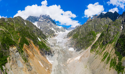 Caucasus Mountains on the border of Russia and Georgia. Chalaat Pass and Very beautiful view of the Chalaadi Glacier, Mount Ushba and Mestiachala river with background of clear blue sky.