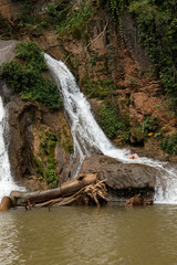 Fototapeta na wymiar Woman Enjoying herself at the Waterfall known as Cachoeira Paraiso do Cerrado located near the city of Mambia and Damianopolis in the State of Goias, Brazil.