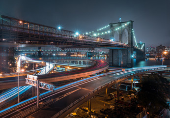 Fototapeta na wymiar Brooklyn Bridge at night, cool tones, long exposure and car lights
