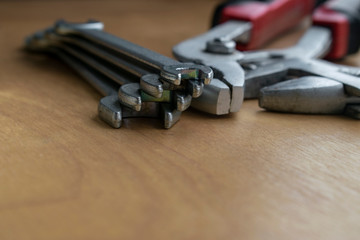 Set of small wrenches. Tool for bolts. Household tools on a wooden table.