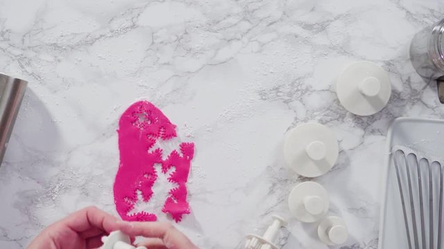Flat lay. Step by step. Rolling our pink fondant on a marble counter.