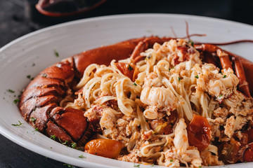 Pasta with Lobster meat on the black wooden background