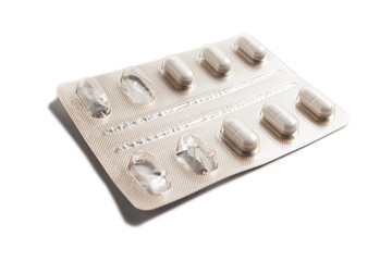 Blister pack of white pills isolated on a white background. Pharmaceutical blister pack. Pack of pills with tablets.