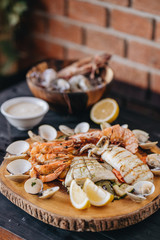 Seafood platter on a black wooden table. Top view